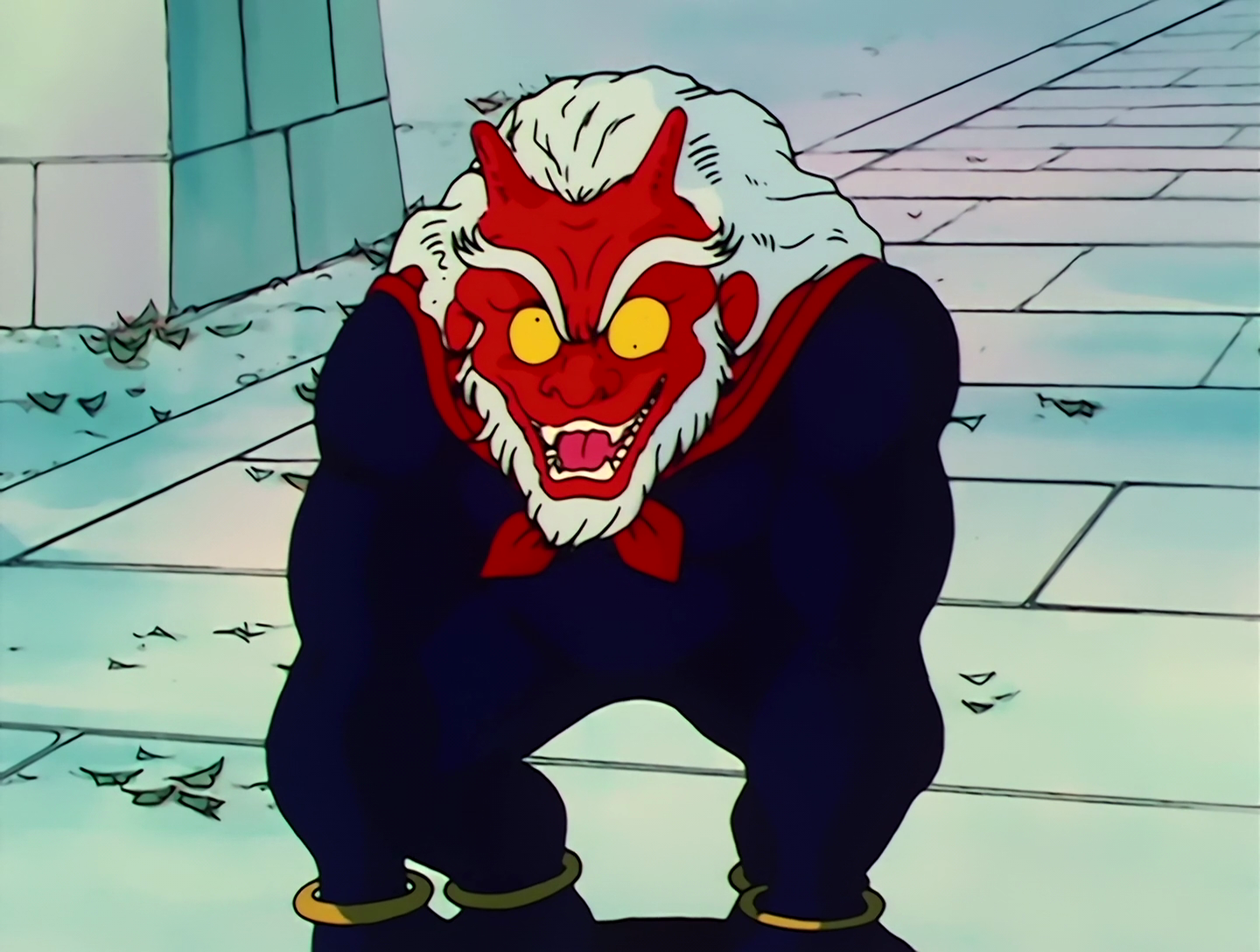 Jiji, a Youma from Sailor Moon episode 30. He has a red face and a white mane of hair, bringing to mind both an oni and a shisa. His eyes are yellow and have very noticeable strabismus. He has a black, hairy, ape-like body and his posture is hunched over. Also for some reason he’s wearing a red neckerchief. Maybe there’s some significance to that, but if not it’s kind of a confusing design element.
